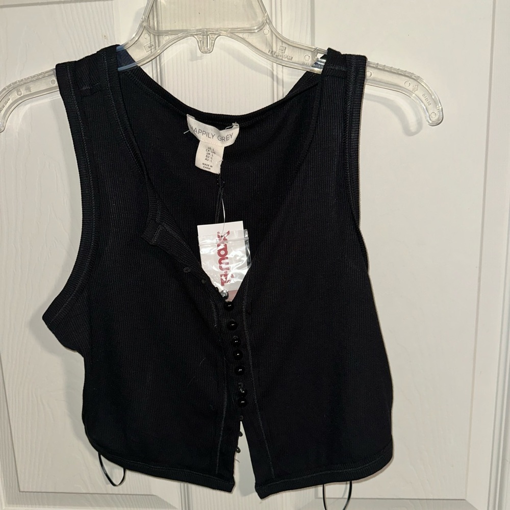 Black tank with delicate buttons.